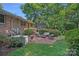 Brick patio with outdoor furniture, grill, and manicured greenery at 5441 Wintercrest Ln, Charlotte, NC 28209