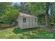 Outdoor storage shed with double doors, windows, and landscaping at 5441 Wintercrest Ln, Charlotte, NC 28209