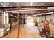 Unfinished basement with exposed ceiling, concrete flooring, workbench, and access to garage at 559 15Th Se Ave, Hickory, NC 28602
