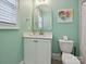 Charming bathroom with green walls, vanity, toilet, mirror, and window with blinds at 7009 Providence W Ln, Charlotte, NC 28226