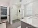 Bright bathroom featuring a glass enclosed shower, soaking tub, and modern finishes at 7009 Providence W Ln, Charlotte, NC 28226