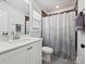 Contemporary bathroom with a large mirror, updated fixtures, and stylish shower curtain providing a luxurious feel at 7009 Providence W Ln, Charlotte, NC 28226