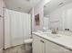 Clean, white bathroom with a shower curtain, white vanity, and sleek fixtures, offering a modern feel at 7009 Providence W Ln, Charlotte, NC 28226