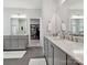 Beautiful primary bathroom featuring double sinks, modern hardware, and access to the closet at 7009 Providence W Ln, Charlotte, NC 28226