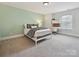 Inviting bedroom features a desk, chair, large window, and a comfortable bed at 7009 Providence W Ln, Charlotte, NC 28226