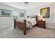 Cozy bedroom with wooden furniture, neutral walls, and soft lighting, creating a warm and inviting atmosphere at 7009 Providence W Ln, Charlotte, NC 28226