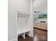 Mud room drop zone with built-in bench and hooks provides a convenient spot to organize belongings at 7009 Providence W Ln, Charlotte, NC 28226