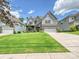 Charming two-story home with stone accents, a well-manicured lawn and a two car garage at 7009 Providence W Ln, Charlotte, NC 28226