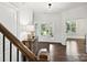 Bright foyer with hardwood floors leading to a front door with sidelights and transom window at 7009 Providence W Ln, Charlotte, NC 28226