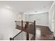 Upstairs hallway with hardwood flooring, built-in shelves, and natural light from the window at 7009 Providence W Ln, Charlotte, NC 28226