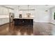 A modern kitchen with stainless steel appliances, white cabinets, and a large island with bar seating at 7009 Providence W Ln, Charlotte, NC 28226