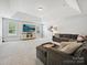 Expansive living room with a coffered ceiling, large TV, and comfortable seating, perfect for relaxation and entertainment at 7009 Providence W Ln, Charlotte, NC 28226