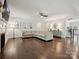 Spacious living room with hardwood floors, fireplace, large sectional, and stylish decor at 7009 Providence W Ln, Charlotte, NC 28226