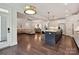 An open-concept kitchen flowing into a cozy living area with a large sectional sofa at 7009 Providence W Ln, Charlotte, NC 28226