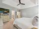 Spacious main bedroom with tray ceiling, ceiling fan, television and ensuite bathroom at 7009 Providence W Ln, Charlotte, NC 28226