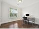 Bright home office with hardwood floors, a window with blinds and a built-in desk at 7009 Providence W Ln, Charlotte, NC 28226