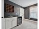 Stylish wet bar area with a wine fridge, sink, and ample storage for entertaining guests and enjoying drinks at 7009 Providence W Ln, Charlotte, NC 28226