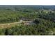 Scenic aerial view of the property surrounded by lush greenery and mature trees at 7032 Waxhaw Hwy, Lancaster, SC 29720