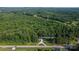 Aerial view of property on a quiet street, featuring mature trees and a sprawling landscape at 7032 Waxhaw Hwy, Lancaster, SC 29720