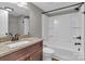 A bathroom features a granite countertop vanity, white toilet, and white tub with shower at 7032 Waxhaw Hwy, Lancaster, SC 29720