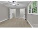 Carpeted bedroom with neutral walls, a ceiling fan, a window, and two closets at 7032 Waxhaw Hwy, Lancaster, SC 29720