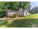 View of home's exterior from the back of the property; features a chimney and a wood deck at 7032 Waxhaw Hwy, Lancaster, SC 29720