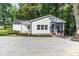 The side exterior of this white home features a screened-in porch and manicured landscaping at 7032 Waxhaw Hwy, Lancaster, SC 29720