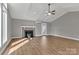 Bright living room with wood floors, fireplace, ceiling fan, and access to outdoor deck at 7032 Waxhaw Hwy, Lancaster, SC 29720