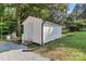 Outbuilding with white siding, stairs, and new gutters on a lush green lot at 7032 Waxhaw Hwy, Lancaster, SC 29720