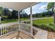 Covered porch of white home features a stone walkway and view of the front yard and surrounding trees at 7032 Waxhaw Hwy, Lancaster, SC 29720