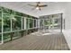 Relaxing screened porch with ceiling fan, wood flooring, and bench seating overlooking the backyard at 7032 Waxhaw Hwy, Lancaster, SC 29720