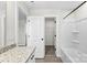 Bright bathroom featuring granite counters, a closet and a shower with white tile surround at 925 Marys Grove Rd, Cherryville, NC 28021