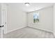 A bedroom featuring a window that provides natural light and neutral carpeting at 925 Marys Grove Rd, Cherryville, NC 28021