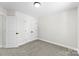 A bedroom featuring neutral carpet, trim, and paint and white closet doors with black hardware at 925 Marys Grove Rd, Cherryville, NC 28021