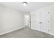 A bedroom with neutral carpet and paint and white trim and doors with black hardware at 925 Marys Grove Rd, Cherryville, NC 28021