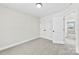 A bedroom with neutral carpet and paint and white trim and doors leading to the hallway at 925 Marys Grove Rd, Cherryville, NC 28021