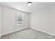 A bedroom with a window that provides natural light and wall-to-wall carpeting at 925 Marys Grove Rd, Cherryville, NC 28021