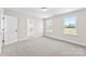 Bedroom with carpet, a door, and two windows offering outside views at 925 Marys Grove Rd, Cherryville, NC 28021