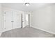 A bedroom with neutral carpet and white trim and white closet doors with black hardware at 925 Marys Grove Rd, Cherryville, NC 28021