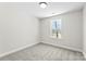 A bright bedroom with a neutral palette and a window providing natural light at 925 Marys Grove Rd, Cherryville, NC 28021