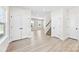 Spacious hallway featuring multiple doors and a staircase with carpet at 925 Marys Grove Rd, Cherryville, NC 28021