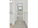 Hallway to bedroom with plush carpeting and view to backyard from window at 925 Marys Grove Rd, Cherryville, NC 28021