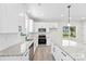 Modern kitchen featuring white cabinets, a granite island, and stainless steel appliances at 925 Marys Grove Rd, Cherryville, NC 28021