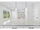 Open kitchen layout with a granite island, pendant lighting, and a view into the living area at 925 Marys Grove Rd, Cherryville, NC 28021