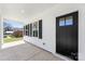 Inviting covered porch with black door, windows, and white siding at 925 Marys Grove Rd, Cherryville, NC 28021