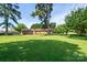 Lush green lawn with mature trees creates a private and serene backyard oasis at 938 Kannapolis Pkwy, Concord, NC 28027