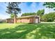 Spacious backyard with a well-maintained lawn and a charming brick home exterior at 938 Kannapolis Pkwy, Concord, NC 28027