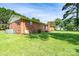 Expansive backyard with a lush lawn and a brick home featuring a cozy patio area at 938 Kannapolis Pkwy, Concord, NC 28027