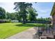 Spacious backyard with a lush lawn, privacy fence, and a detached garage in the distance at 938 Kannapolis Pkwy, Concord, NC 28027