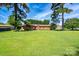 Expansive backyard with mature trees and a well-maintained lawn provides ample space for outdoor activities at 938 Kannapolis Pkwy, Concord, NC 28027